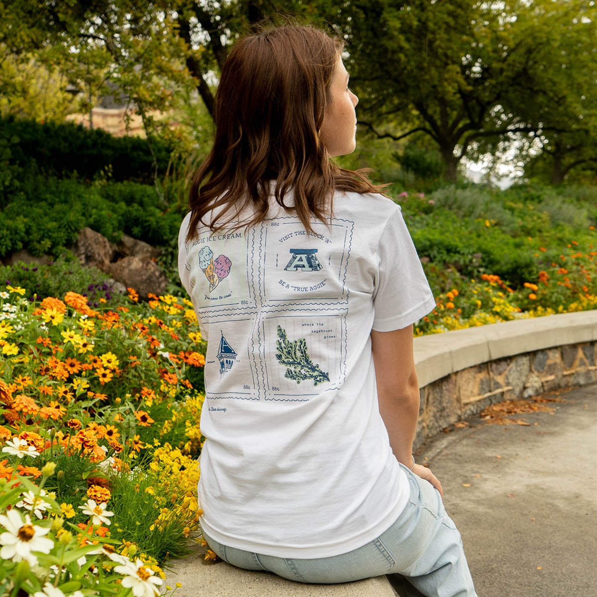 Young woman wearing white utah state postage stamp t-shirt